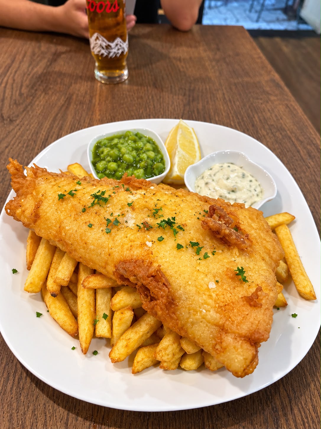 Battered cod with chips, peas, lemon and tartare sauce